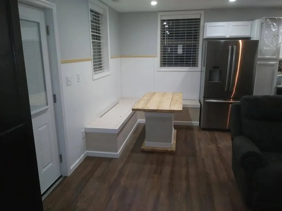 Custom kitchen nook with built-in bench, wainscot and butcher-block table by Mote's Construction